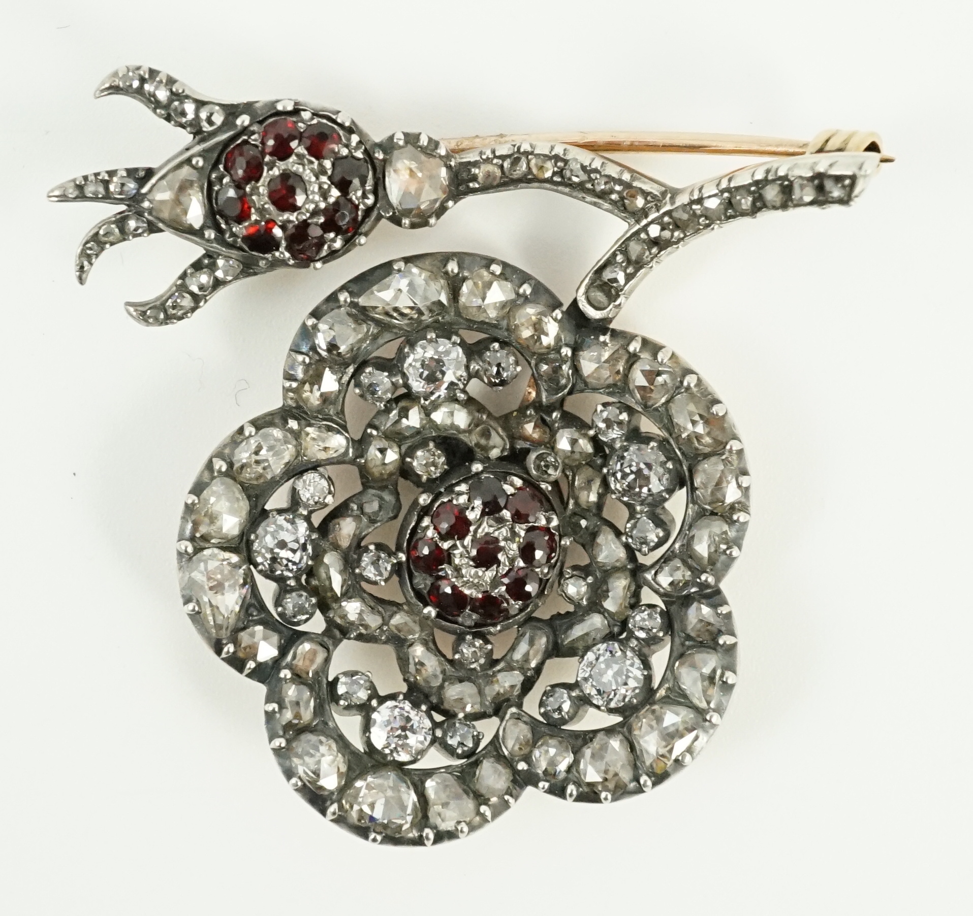 A Victorian, gold and silver, old and rose cut diamond and garnet cluster set pansy brooch